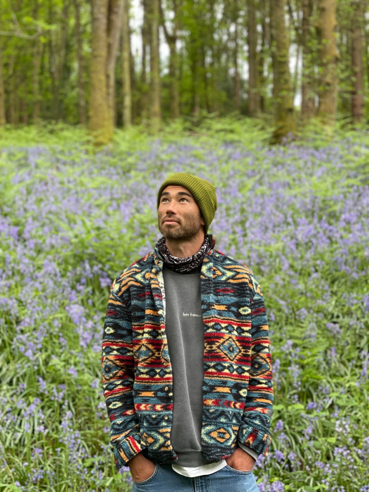 Harry standing in a bluebell wood, contemplative and at peace