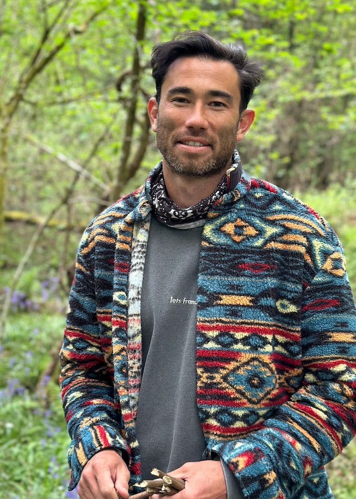 Harry Bucknell — founder of Wilding, smiling warmly in woodland